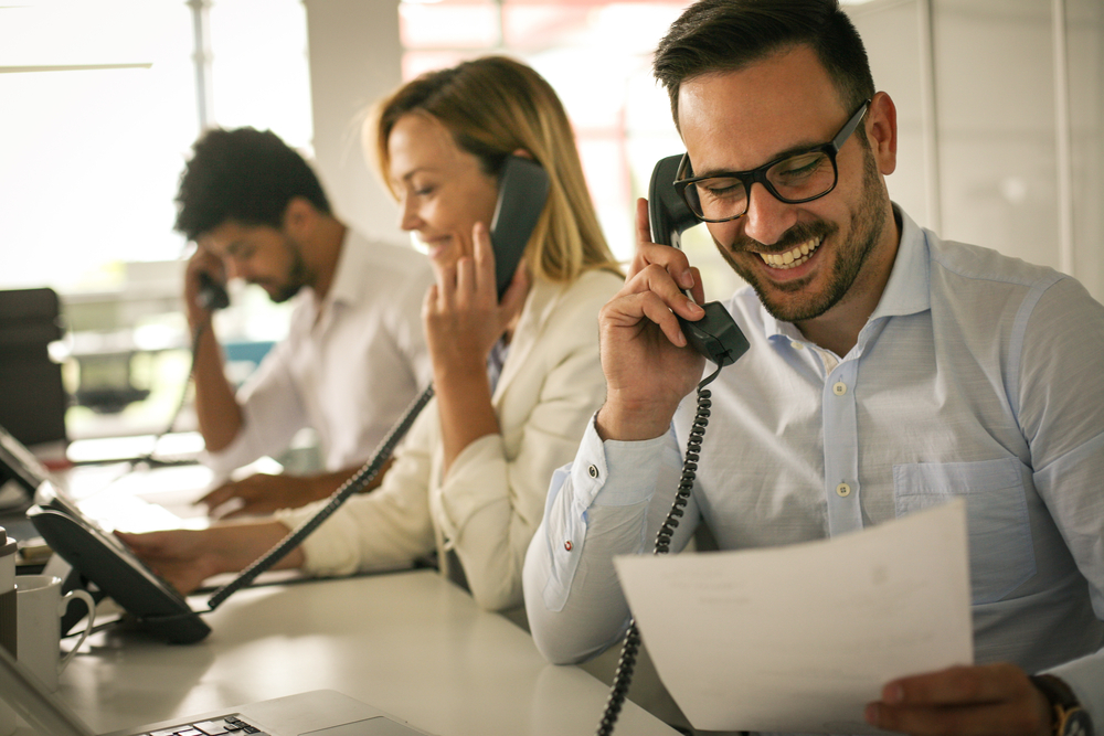 A health insurance agent is taking a phone call