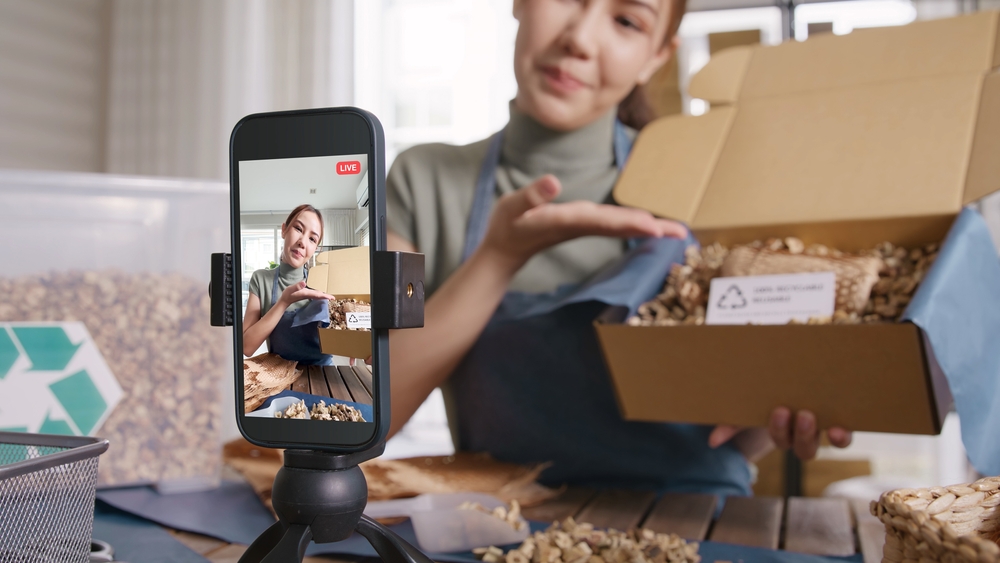 A female YouTuber is unpacking a product in front of her audience